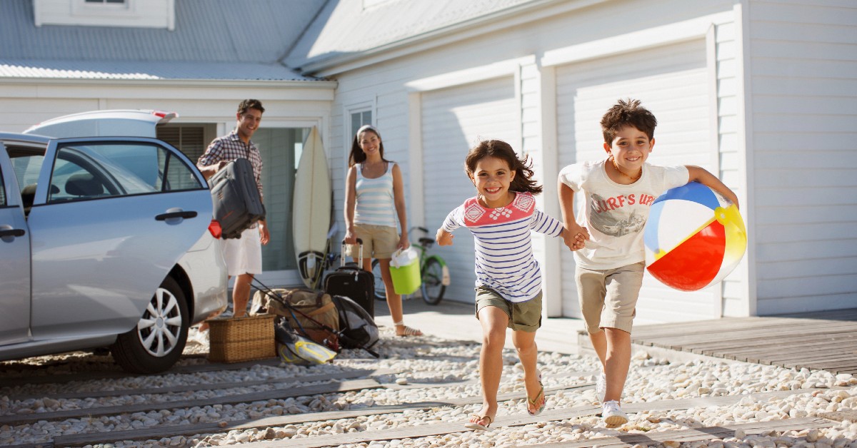 Parents and two children entering their summer vacation home.