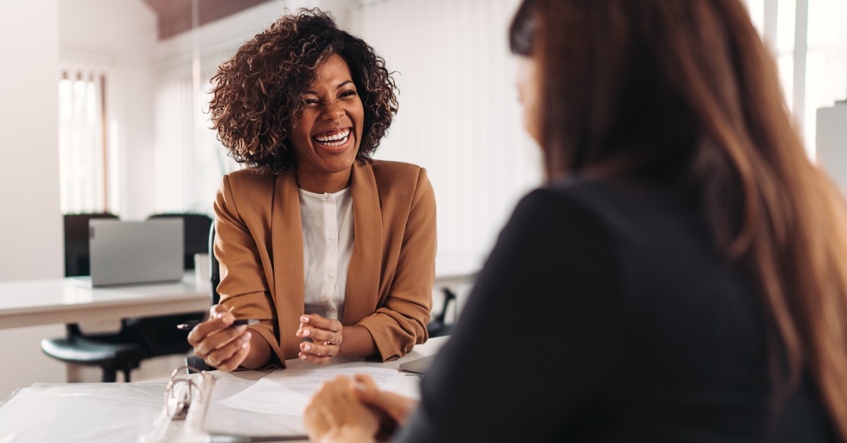 Business woman smiling during meeting with her insurance broker.